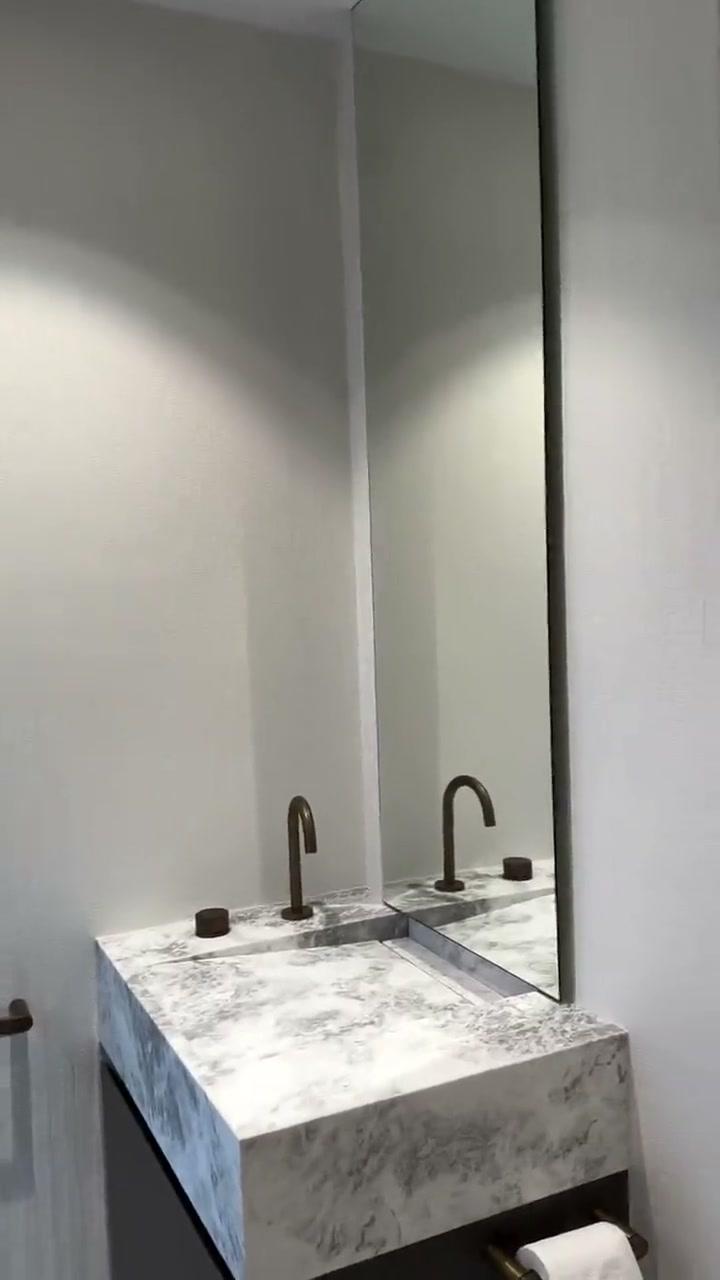 Pale satin-sealed Bamboo texture running through a pool bathroom, behind a marble basin and bronze tapware